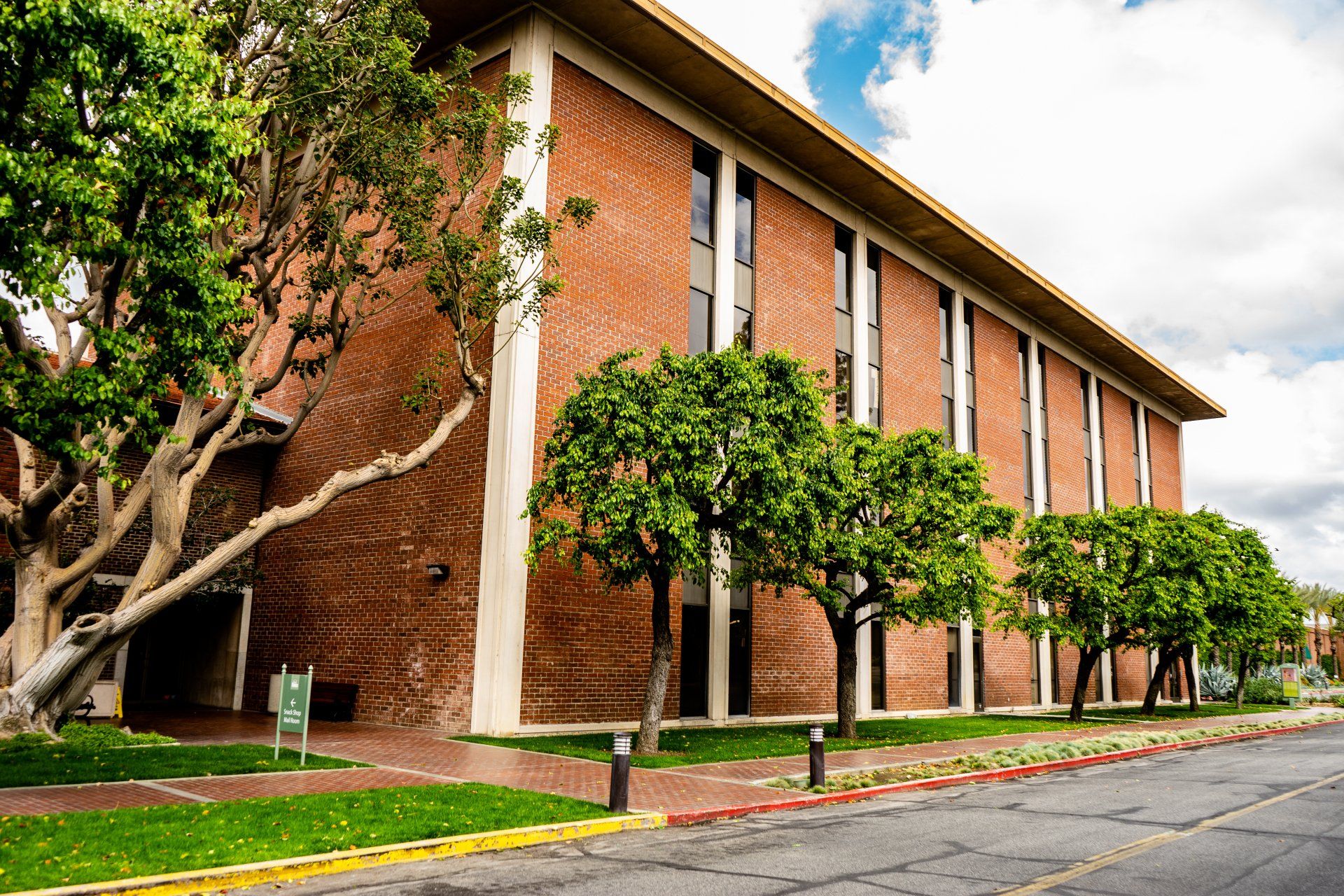 A large brick building with trees in front of it